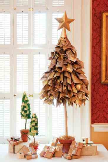Handmade recycled newspaper and cardboard trees, "planted" in terra cotta pots, top a table of gifts wrapped in recycled paper. (Find instructions to make both trees at www.naturalhomemagazine.com.)